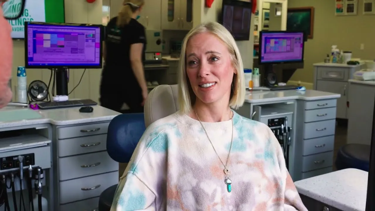 Smiling young woman sharing her experience at Macdonald Orthodontics