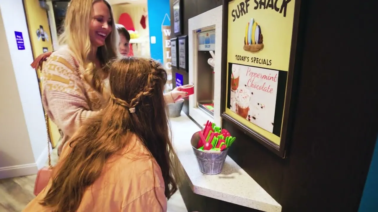 Two kids enjoying treats together at a candy shop